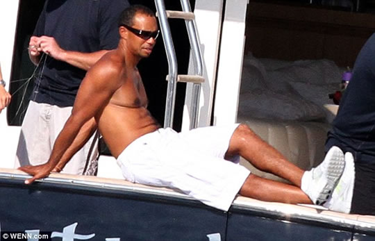 Tiger Woods Relaxes with Man Boobs